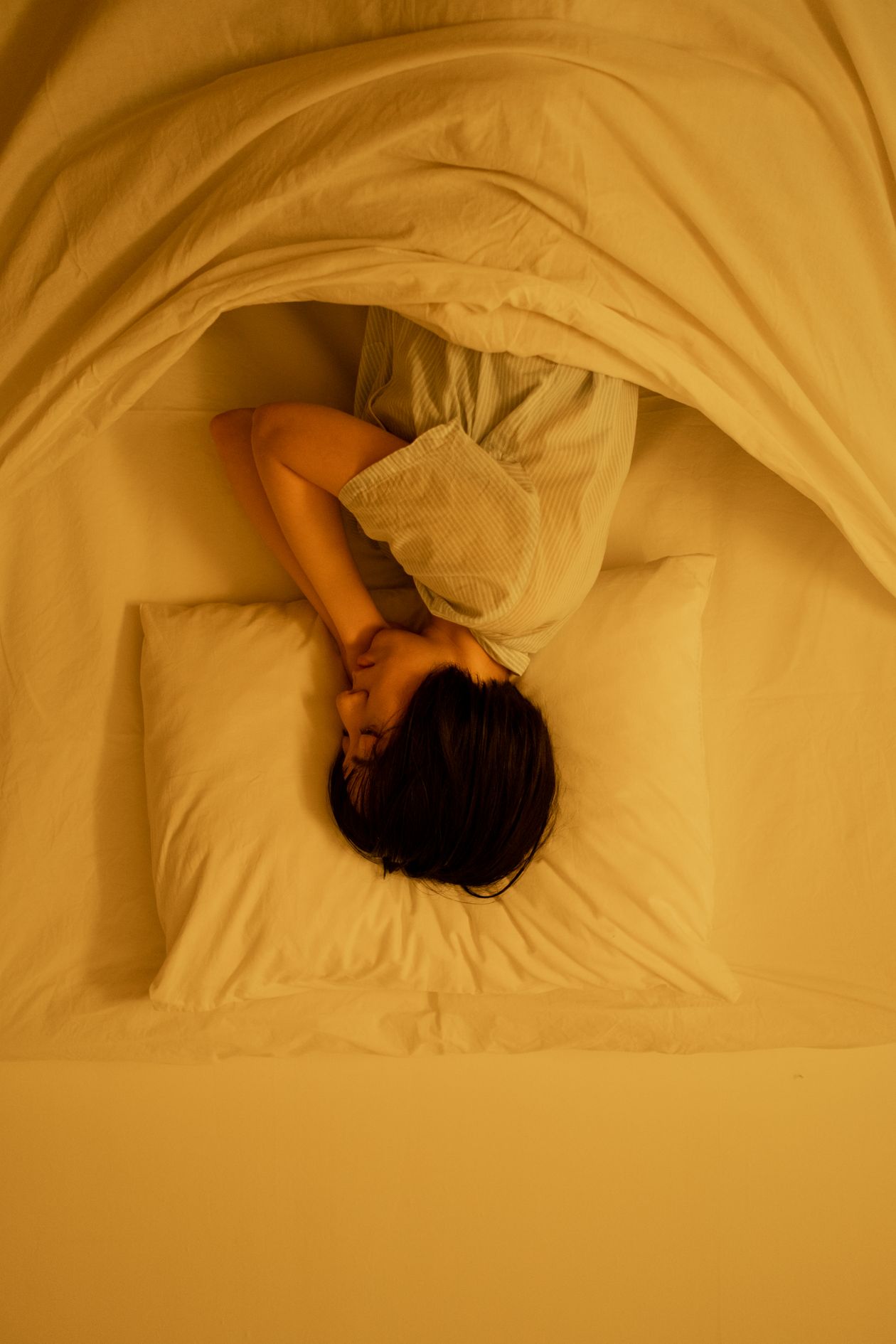 Person sleeping on their side in a supportive position — back and neck pain, Saint Paul Park MN