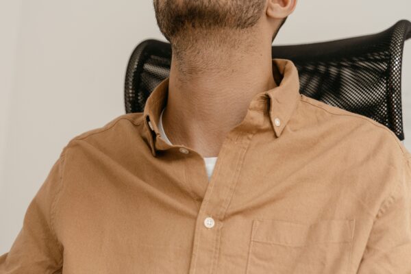 Tired office worker leaning back in a desk chair — low back pain from sitting, Saint Paul Park MN