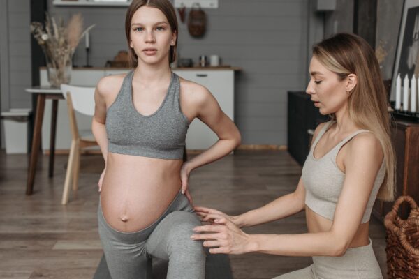 Pregnant woman doing a gentle, supported stretch — pregnancy-adapted chiropractic care, Saint Paul Park MN